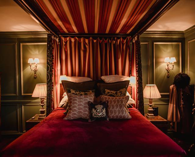 Velvet four poster bed in The Guardroom romantic suite at Secret hotel The Witchery in Edinburgh