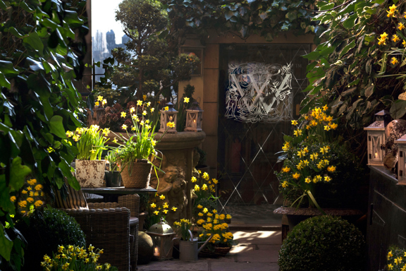 The Secret Garden at the Witchery in Spring with flowers and an entrance to the restaurant