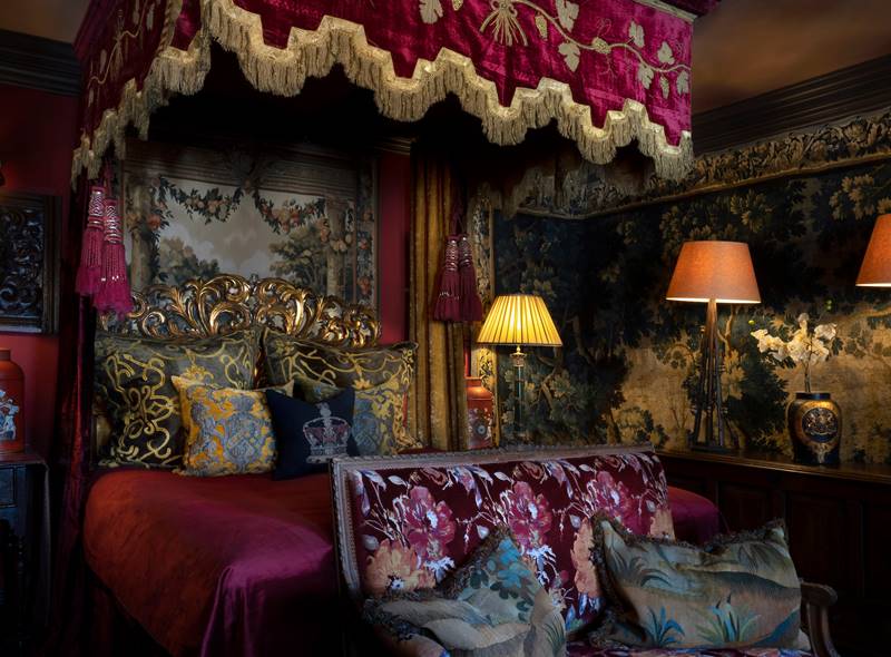 Antique tapestry walls and decadent velvet gothic bed, in The Turret luxury hotel suite at The Witchery.