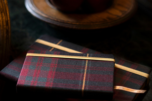 Tartan notebook sat on a marble desk