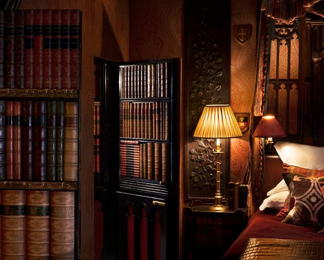 Secret door hidden in bookcase within The Library, a Gothic hotel suite near Edinburgh Castle, UK