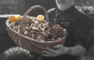Chef at The Witchery with a basket of Seafood