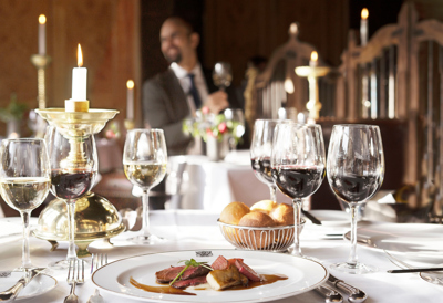 Plate of food and glasses of wine at The Witchery