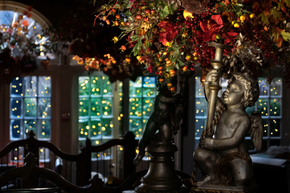 Cherub statue holding flowers found in The Witchery
