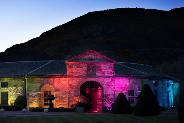 Stables lit up in rainbow
