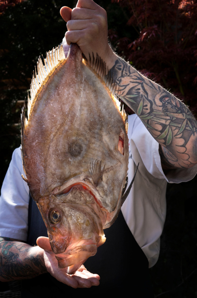 Chef at The Witchery holding fresh fish