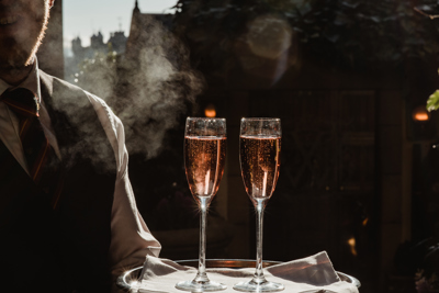 Champagne being served with Edinburgh street in the background