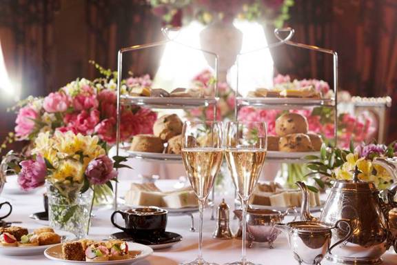Champagne, tea, silver cake stands and pink flowers shown in Rhubarb, the best Edinburgh restaurant for afternoon tea